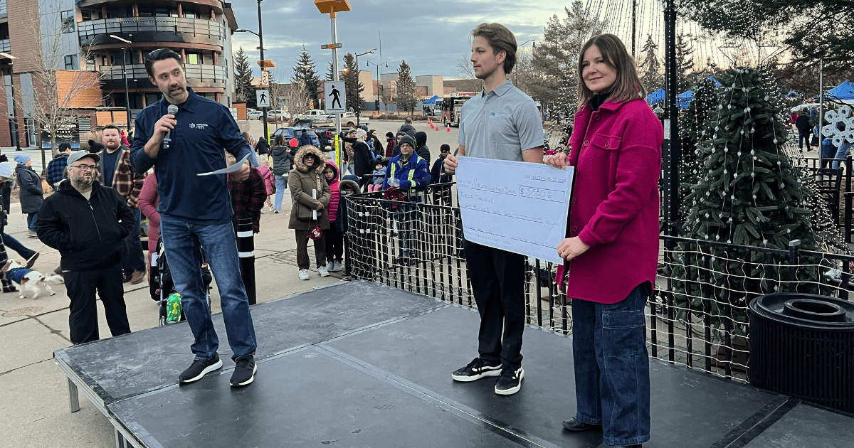 A picture of people on stage with an over sized cheque ot the Strathcona Food Bank