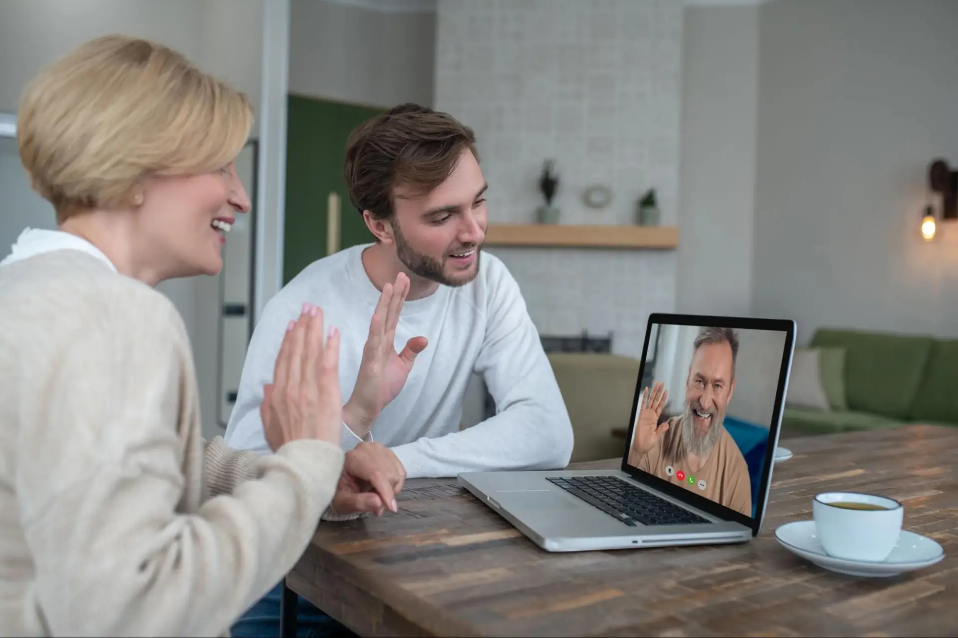 People participating in a video call from home, illustrating how video communication increases upload demands for reliable internet connectivity.