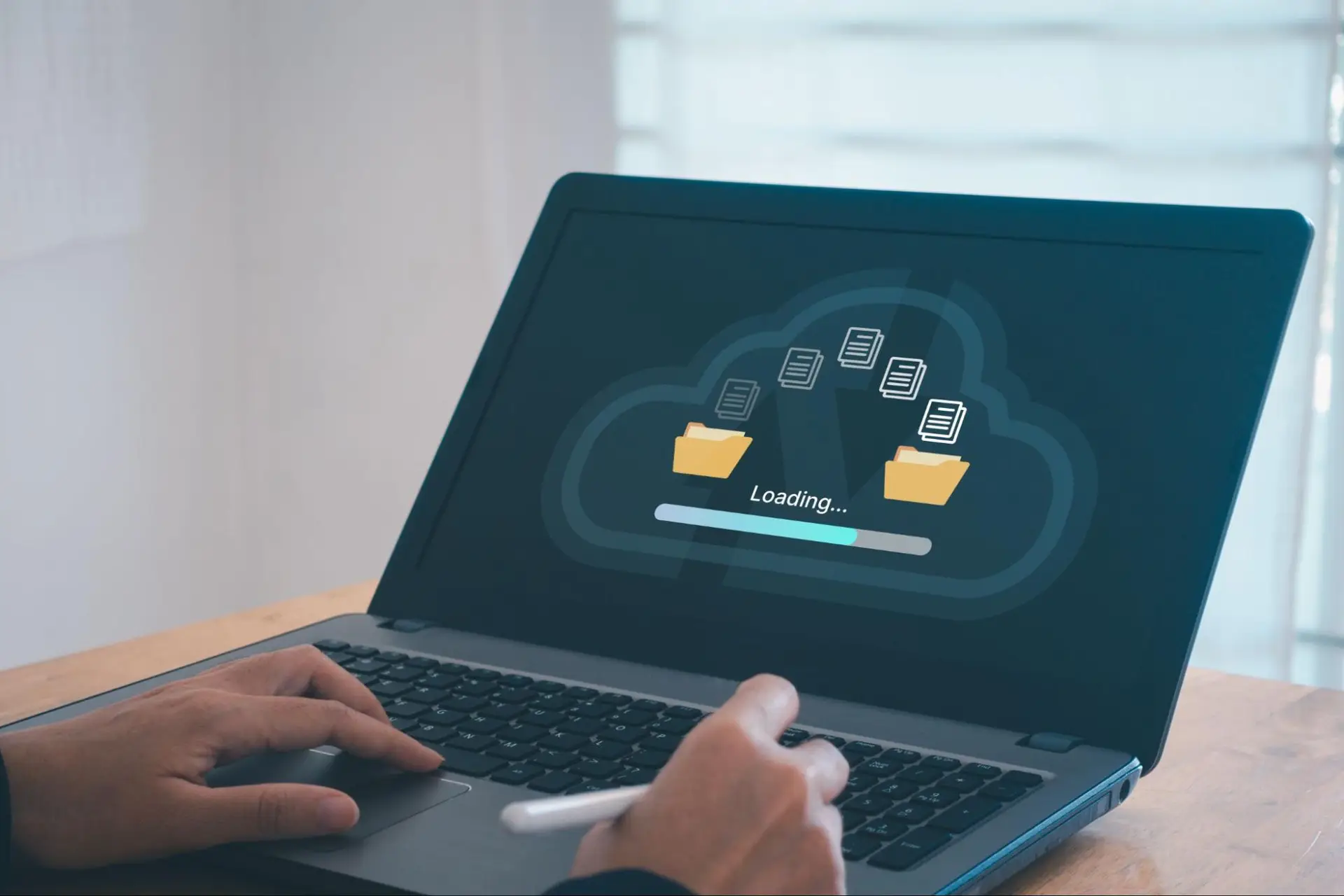 Person using a laptop with cloud storage, illustrating why fast upload speeds are important for file sharing, remote work, and online connectivity.