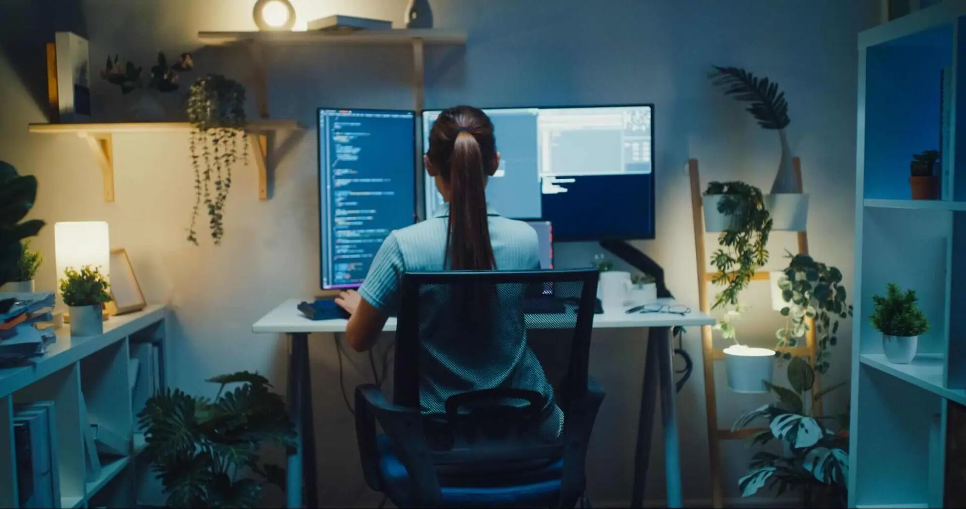 Person working at a home office with multiple monitors, representing the importance of reliable upload speeds for video calls, remote work, and connected devices.