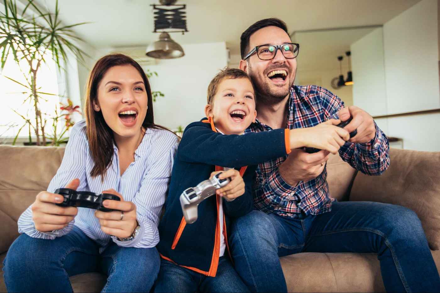 Family enjoying online gaming at home, illustrating how fiber delivers faster, more reliable internet than older infrastructure.