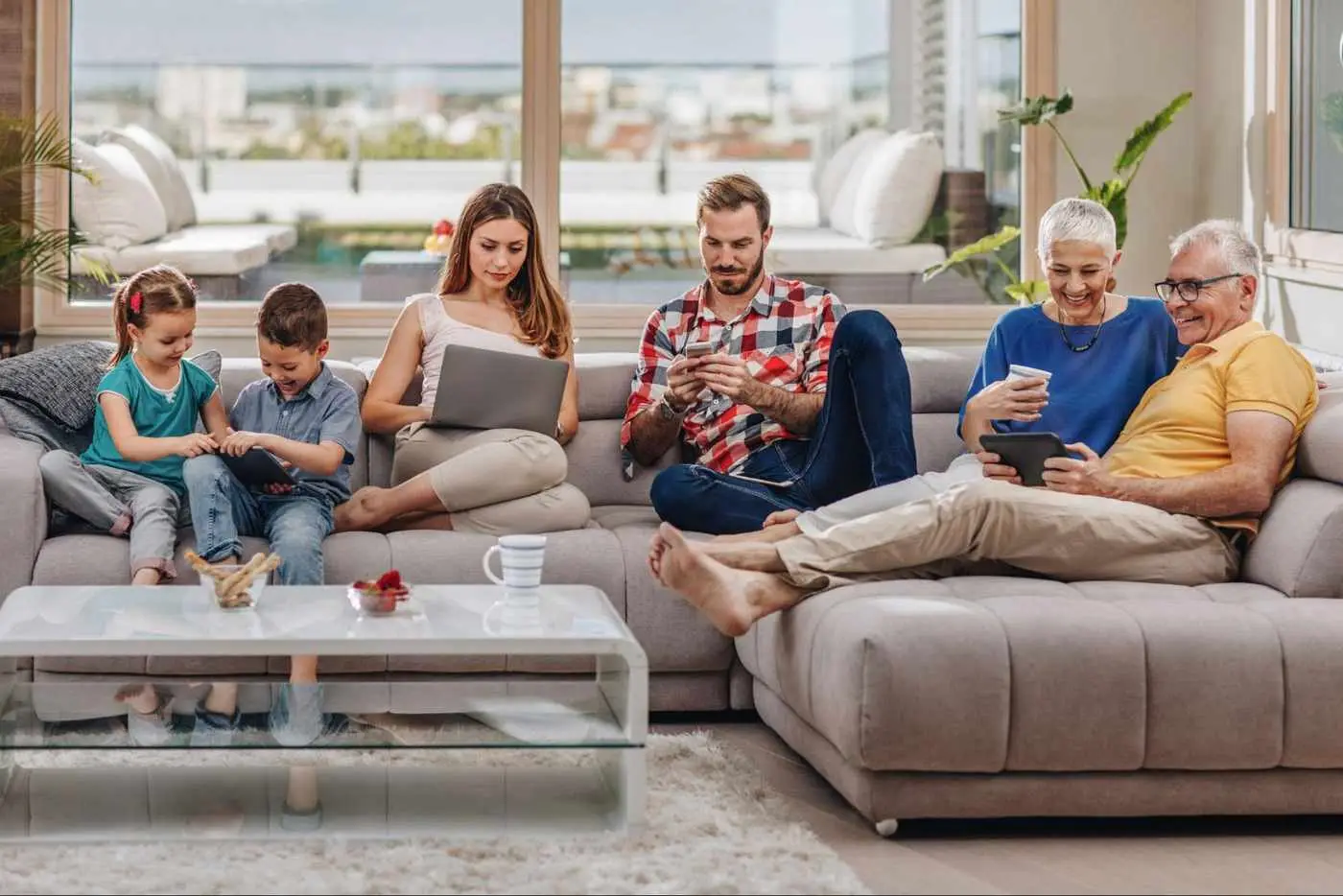 Family using multiple devices at home, demonstrating the consistent year-round connectivity supported by underground fiber internet.
