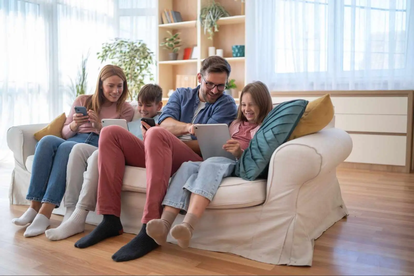 Alberta family using multiple connected devices at home, illustrating the internet speeds needed for everyday browsing, streaming, and online activities.