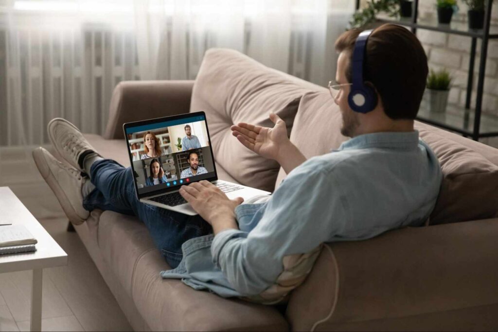 Man on a video call from his laptop at home, illustrating why upload speed is increasingly important for reliable internet.